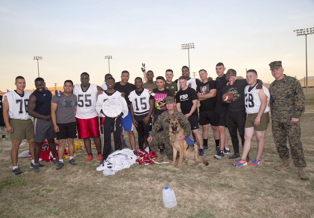 Marine Reservist assigned to Fleet Support Division, are all smiles while displaying the championship trophy the team won after beating the MCLB Barstow Marines during the Turkey Bowl held aboard Marine Corps Logistics Base Barstow Nov. 21.