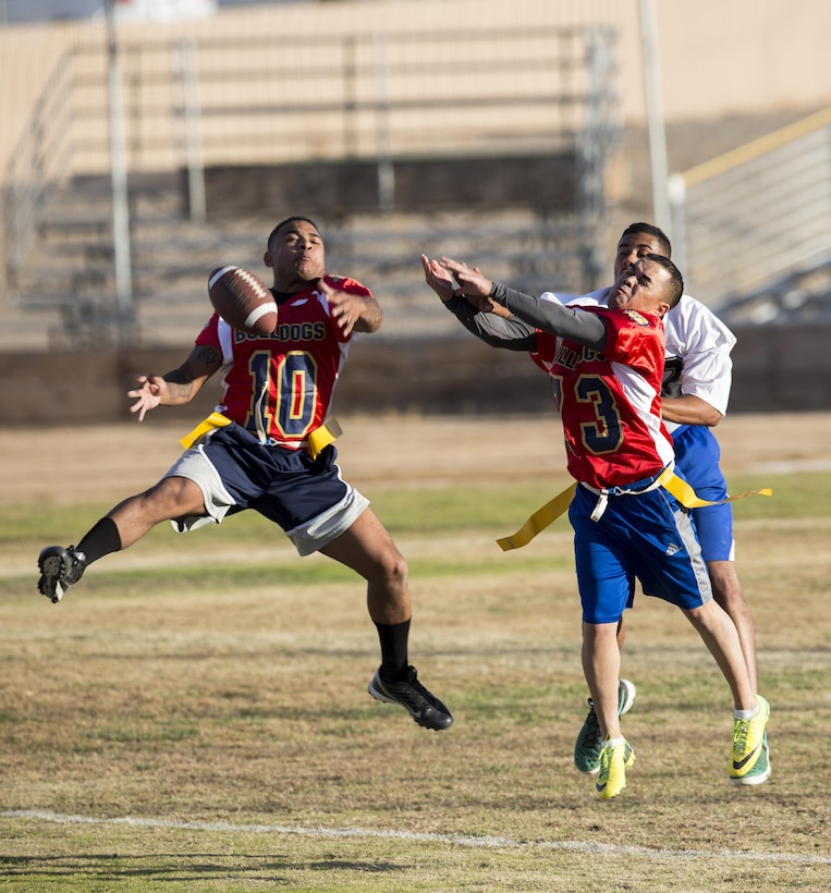 Sgt. Xzavier Wolef (left) and Staff Sgt. Pedro Villa knock down a pass attempt during the first half of thi year's Turkey Bowl, pitting MCLB Barstow Marines against Marine reservist assigned to Fleet Support Division Nov. 21 aboard Marine Corps Logistics Base Barstow.