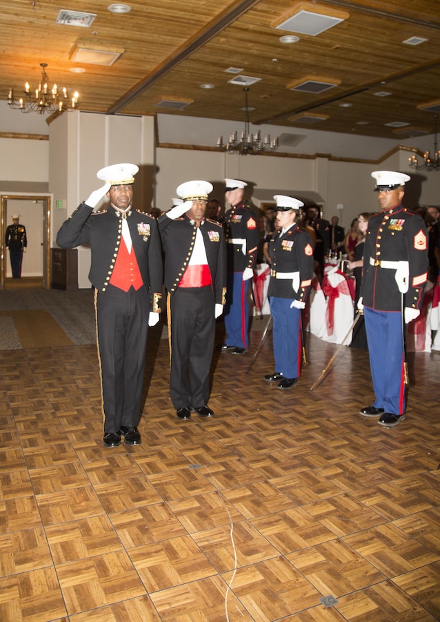 Lieutenant General Ronald Bailey, USMC Retired, and Colonel Sekou Karega, commading officer, Marine Corps Logistics Base Barstow, salute the American Flag and Marine Corps Colors during the 242nd Marine Corps Birthday Ball held at Big Bear Lodge, Big Bear, Calif., Nov. 18.