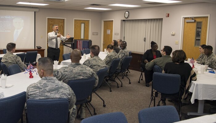 Mick Mahon, 628th Force Support Squadron transition management consultant discusses the Wounded Warrior Program and the services available to wounded, ill or injured veterans while in the program during the Second Annual Warrior Care Breakfast and Information Fair at the Airman & Family Readiness Center here Nov. 29, 2017.