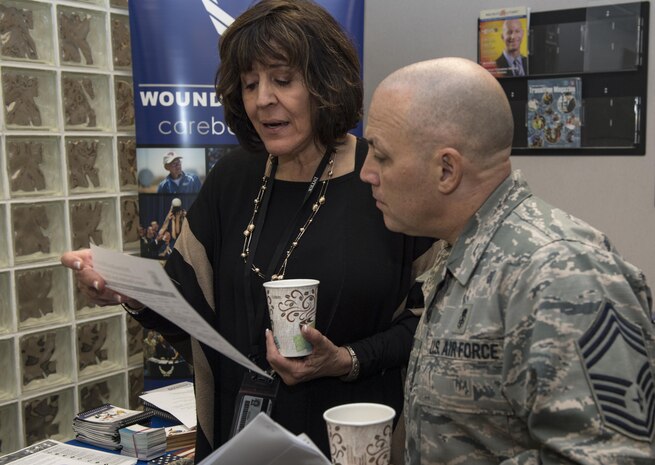 Ivette Bohannan-Bagnato, Air Force Wounded Warrior Program regional care coordinator, speaks with Chief Master Sgt. Joseph Powell, 628th Medical Group superintendent, about the Wounded Warrior Program and the initial steps every Airmen takes upon entering the program during the Second Annual Warrior Care Breakfast and Information Fair at the Airman & Family Readiness Center here Nov. 29, 2017.