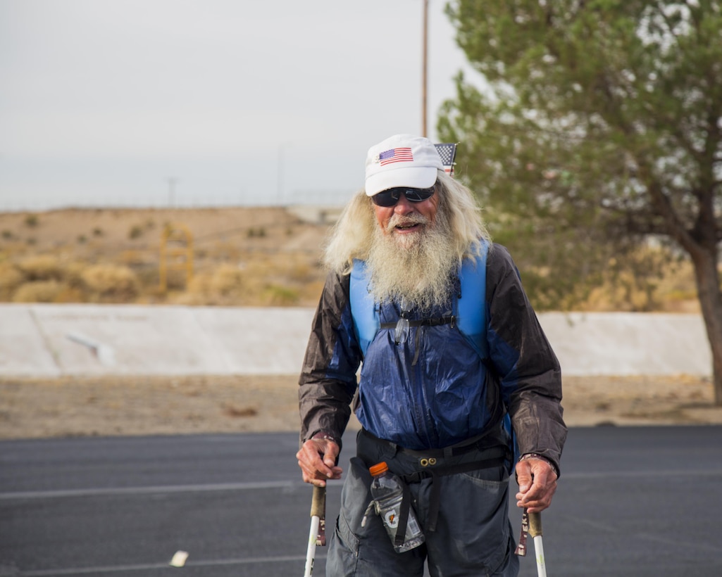 Meredith J. Eberhart, an 80-year-old retired optometrist and Coast Guard veteran, pauses for a photos as he walks through Marine Corps Logistics Base Barstow, as part of his trek along Route 66 from Chicago, Ill., to Santa Monica, Calif. Nov. 15. He is a long distance, Triple Crown, hiker and author and uses the hikes to raise awareness and funds for various charities. This walk is dedicated to veterans.