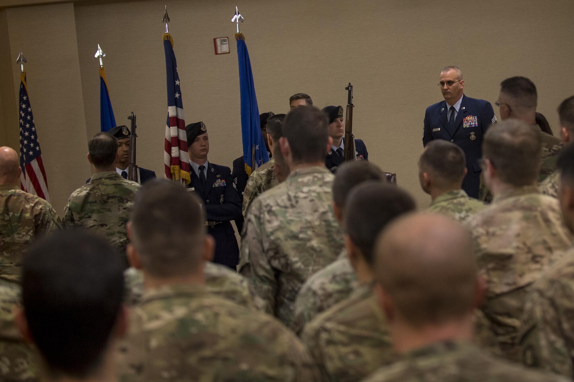 Airmen from the 820th Base Defense Group stand at attention during the presentation of the colors at a retirement ceremony for Chief Master Sgt. David Houtz, 823d Base Defense Squadron chief enlisted manager, Dec. 1, 2017, at Moody Air Force Base, Ga. Houtz enlisted in the Air Force on Oct. 6, 1991. During his 27-year career, he has held numerous leadership roles while supporting Operations Provide Promise, Southern Watch, Enduring Freedom, Iraqi Freedom and Inherent Resolve. (U.S. Air Force photo by Senior Airman Daniel Snider)