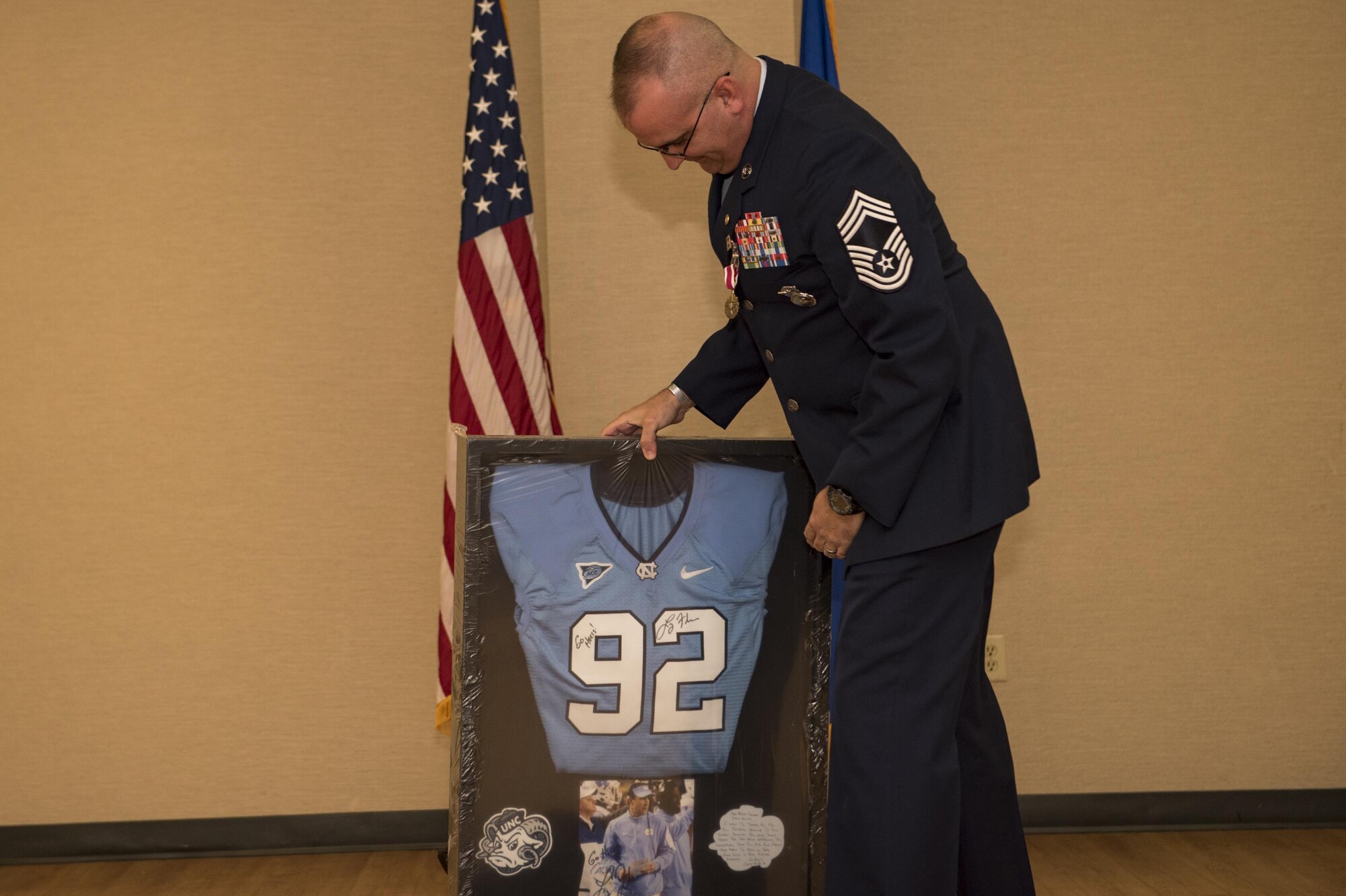 Chief Master Sgt. David Houtz, 823d Base Defense Squadron chief enlisted manager, opens a gift during his retirement ceremony, Dec. 1, 2017, at Moody Air Force Base, Ga. Houtz enlisted in the Air Force on Oct. 6, 1991. During his 27-year career, he has held numerous leadership roles while supporting Operations Provide Promise, Southern Watch, Enduring Freedom, Iraqi Freedom and Inherent Resolve. (U.S. Air Force photo by Senior Airman Daniel Snider)