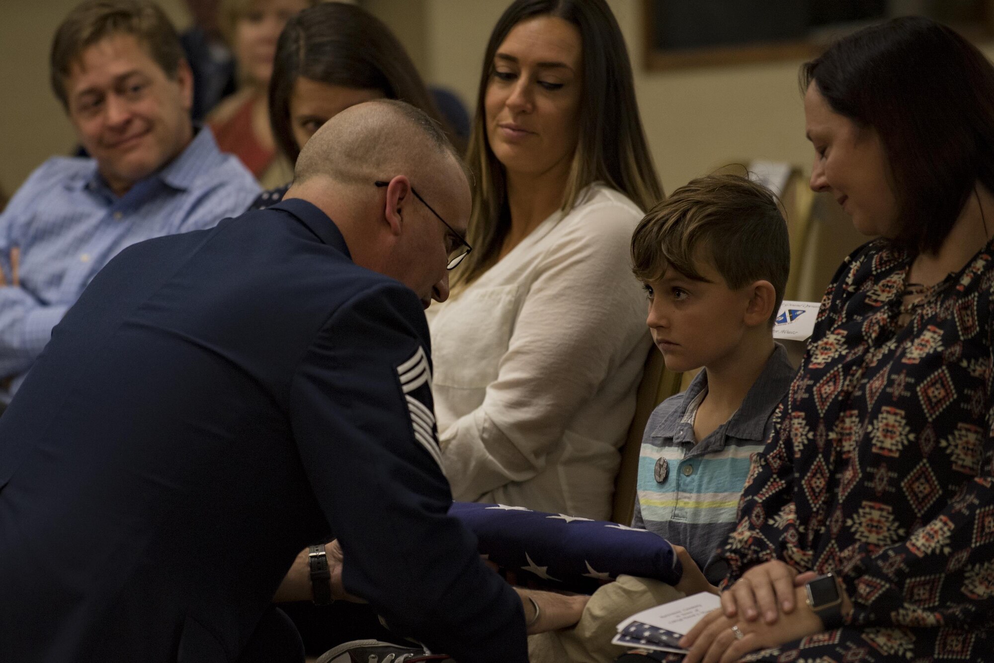 Chief Master Sgt. David Houtz, 823d Base Defense Squadron chief enlisted manager, presents his son, Logan, with a U.S. flag during Houtz’s retirement ceremony, Dec. 1, 2017, at Moody Air Force Base, Ga. Houtz enlisted in the Air Force on Oct. 6, 1991. During his 27-year career, he has held numerous leadership roles while supporting Operations Provide Promise, Southern Watch, Enduring Freedom, Iraqi Freedom and Inherent Resolve. (U.S. Air Force photo by Senior Airman Daniel Snider)