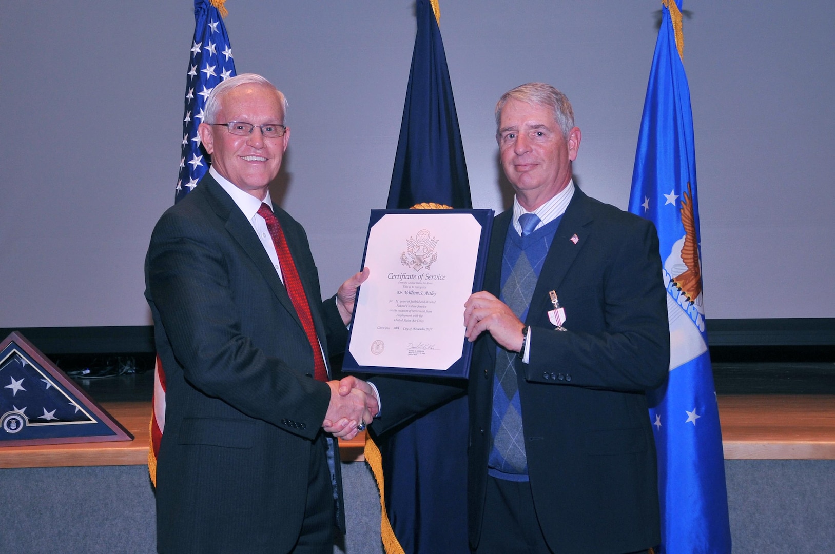 Patrick McVay (left), U.S. Strategic Command (USSTRATCOM) director of joint exercises, training and assessments, presents a certificate of service to Dr. William Astley, USSTRATCOM resiliency coordinator, during Astley’s retirement ceremony at Offutt Air Force Base, Neb., Nov. 30, 2017. Astley retired after 36-plus years of service as an Air Force officer and government civilian. Throughout his 11 years with USSTRATCOM, Astley led a team that developed several programs and activities to ensure members of the command remain sharp, fresh and productive. One of nine Department of Defense unified combatant commands, USSTRATCOM has global responsibilities assigned through the Unified Command Plan that include strategic deterrence, nuclear operations, space operations, joint electromagnetic spectrum operations, global strike, missile defense, and analysis and targeting.