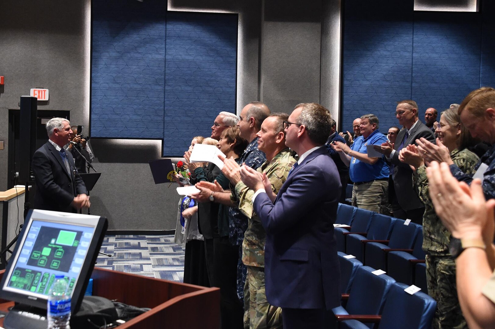 Dr. William Astley, U.S. Strategic Command (USSTRATCOM) resiliency coordinator, receives a standing ovation following his retirement ceremony at Offutt Air Force Base, Neb., Nov. 30, 2017. Astley retired after 36-plus years of service as an Air Force officer and government civilian. Throughout his 11 years with USSTRATCOM, Astley led a team that developed several programs and activities to ensure members of the command remain sharp, fresh and productive. One of nine Department of Defense unified combatant commands, USSTRATCOM has global responsibilities assigned through the Unified Command Plan that include strategic deterrence, nuclear operations, space operations, joint electromagnetic spectrum operations, global strike, missile defense, and analysis and targeting.