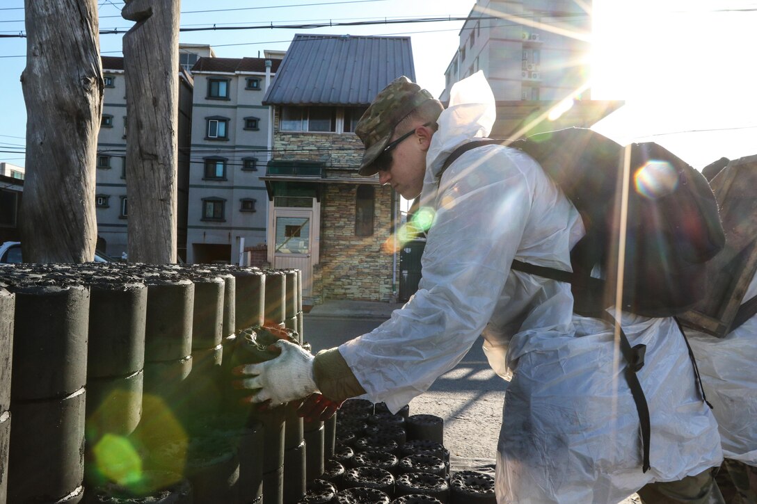 Soldiers deliver charcoal briquettes to less fortunate families in Dongducheon, South Korea.