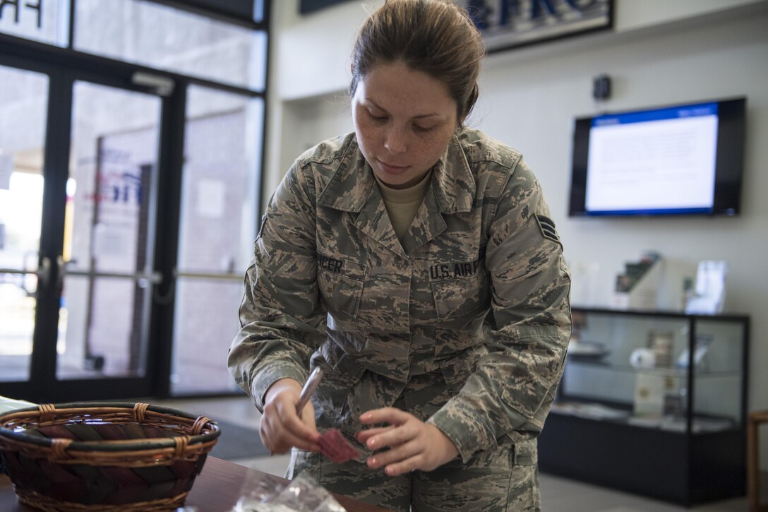 Senior Airman Emily Spicer, 23d Force Support Squadron fitness specialist, fills out a ticket for a door prize giveaway during the Airmen and Family Readiness Center’s (AFRC) ‘grand reopening’, Nov. 29, 2017, at Moody Air Force Base, Ga. The AFRC relocated to the Freedom 1 Fitness Center, but held the event as the grand finale to their month of the military family campaign and to showcase their new location to Moody. (U.S. Air Force photo by Senior Airman Janiqua P. Robinson)