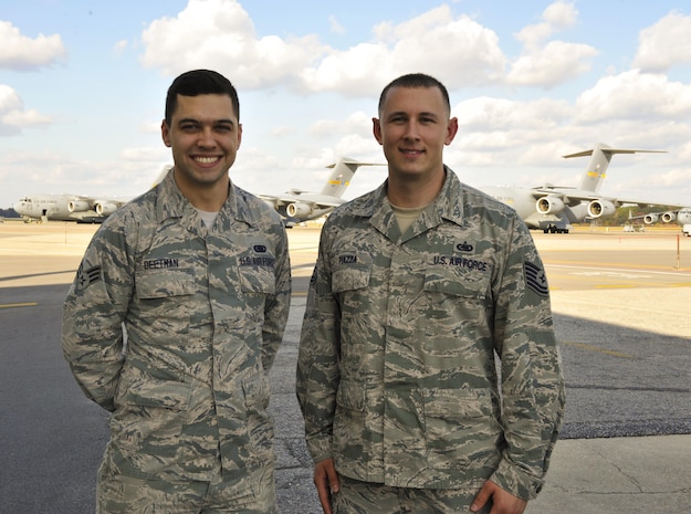 Senior Airman Ryan Deetman, left, 628th Logistics Readiness Squadron central storage journeyman, poses with Tech. Sgt. Dominic Piazza, 628th LRS central storage supervisor in front of the flightline at Joint Base Charleston, S.C., Nov. 30, 2017.