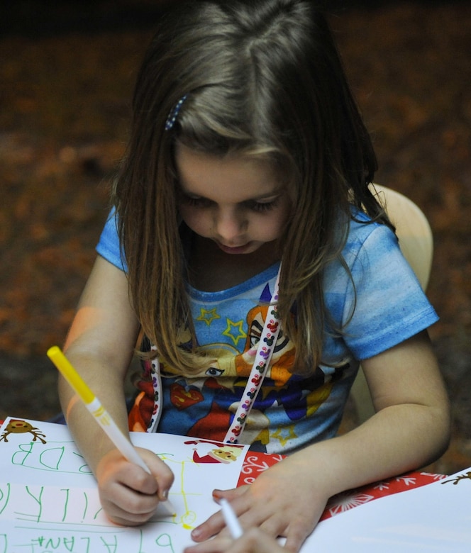 Ally, a child attending the tree lighting holiday celebration, writes her letter to Santa at Joint Base Charleston – Weapons Station, S.C., Nov. 30, 2017.