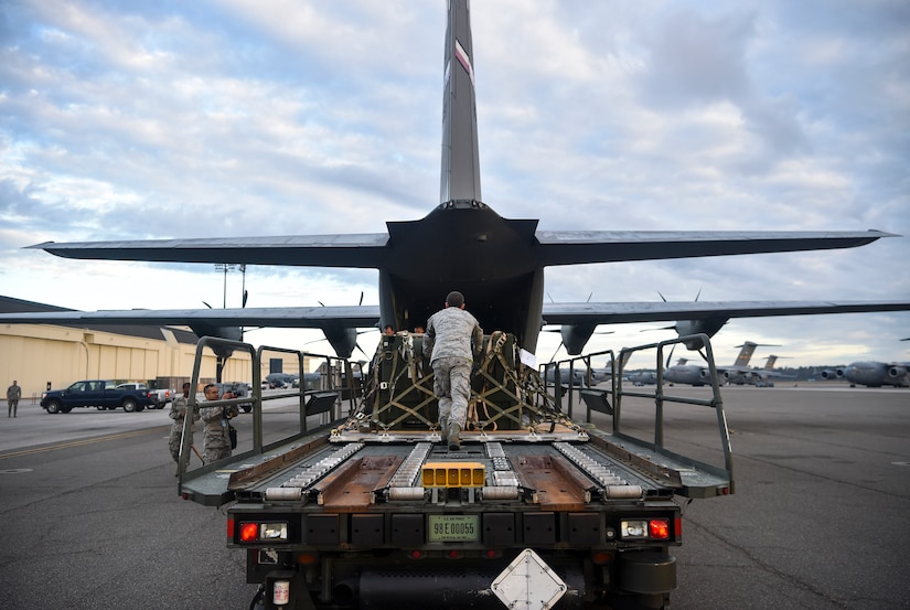 Senior Airman Zachary Payne, 437th Aerial Port Squadron air cargo services technician, helps push cargo onto a Dyess Air Force Base C-130 Hercules at Joint Base Charleston, S.C., Nov. 29, 2017.