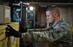 Staff Sgt. George Garner, 437th Aerial Port Squadron shift supervisor, steadies cargo during a pallet build at Joint Base Charleston, S.C., Nov. 29, 2017.