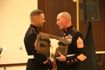 Sergeant Major Christoper Farrell, Sergeant Major, Recruiting Station Kansas City, presents Staff Sgt Larrykeith Conlkin with the Recruiter of the Year award for his efforts during fiscal year 2017. Staff Sgt Conklin contracted more than 30 new Marines as well as conducting more than 100 school visits during the fiscal year.