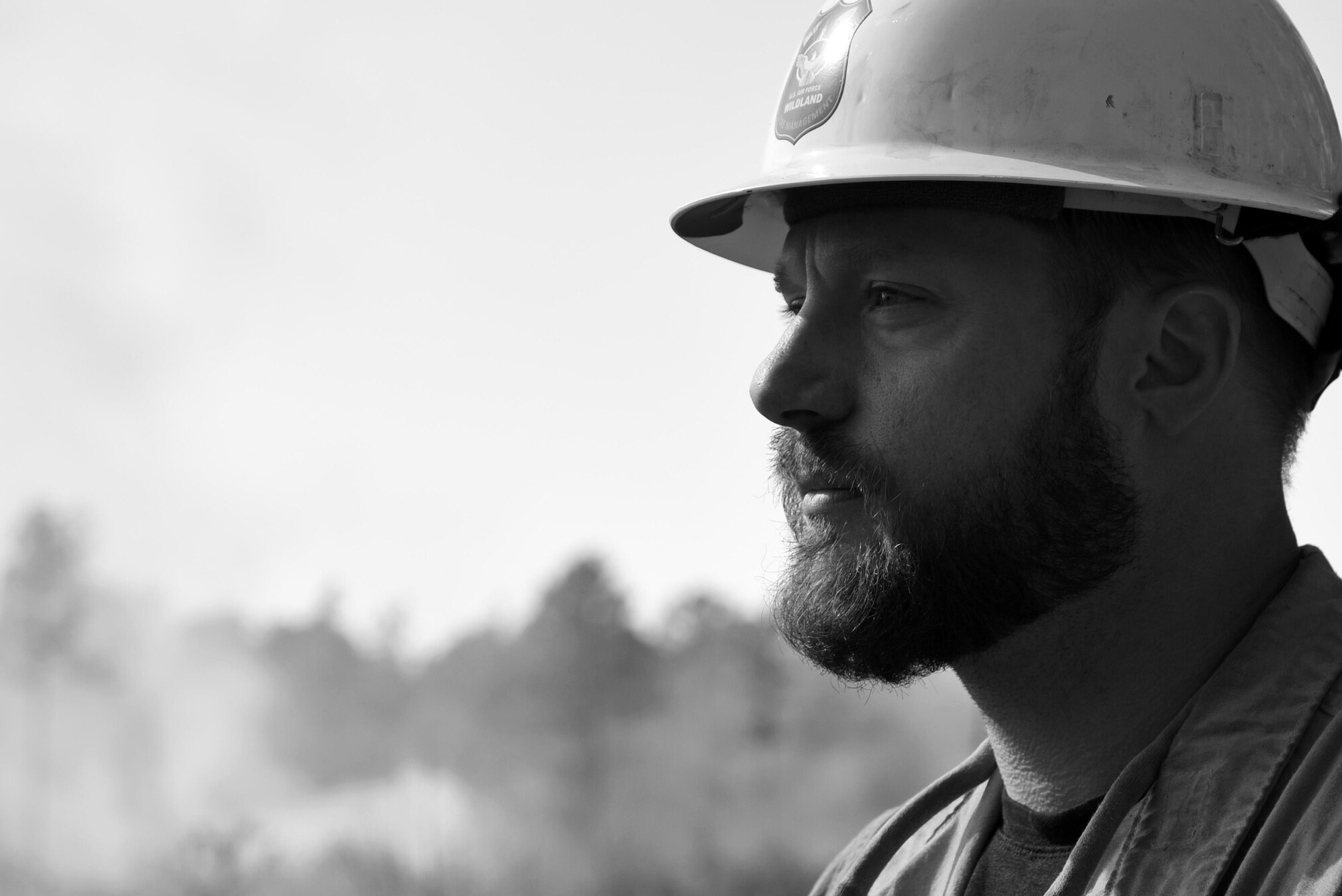 Brock Williams, Shaw Wildland Support Module assistant module leader, stands near a prescribed fire at Poinsett Electronic Combat Range near Wedgefield, South Carolina, Nov. 29, 2017.