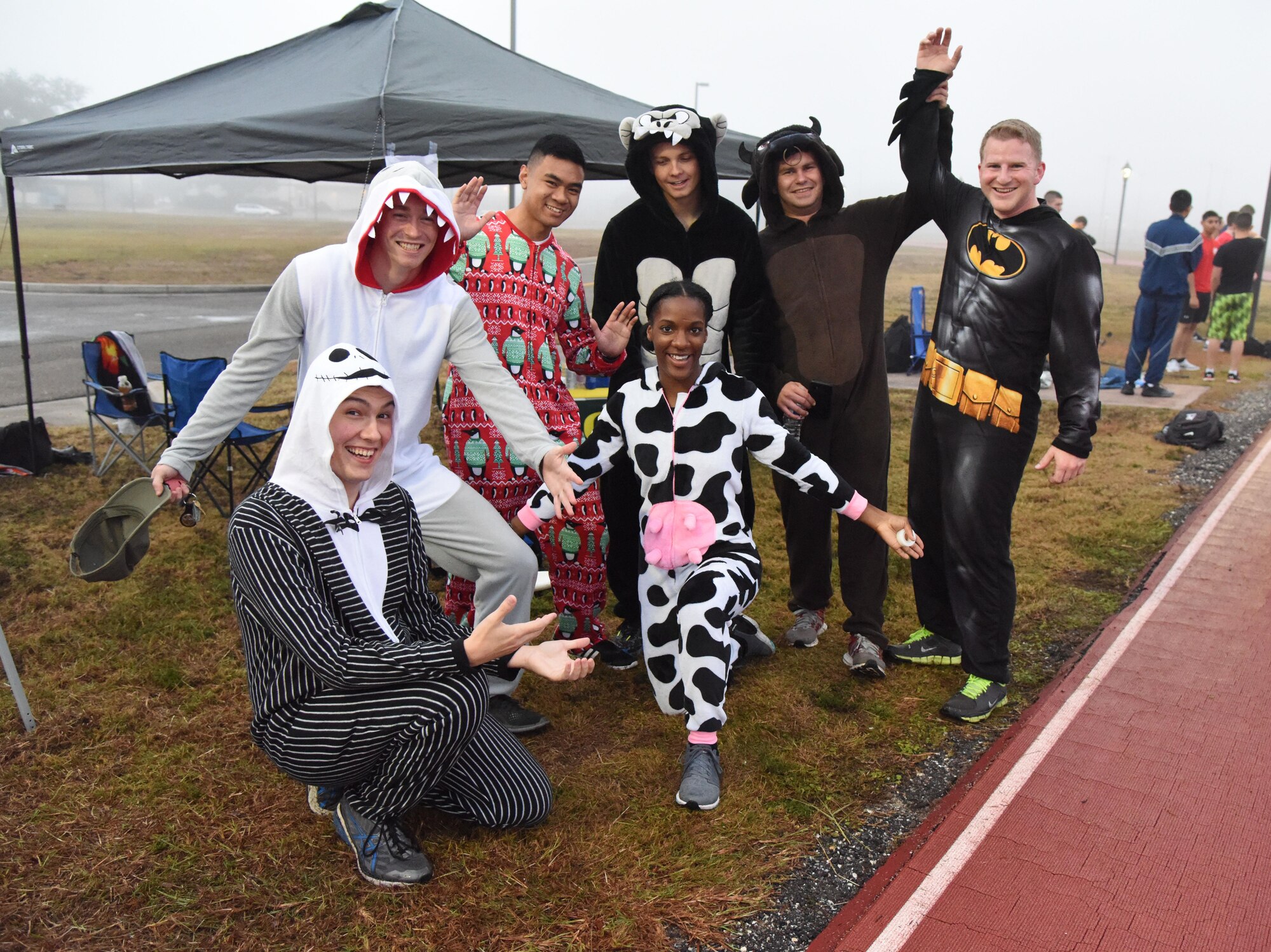 Members of the 81st Communications Squadron display their costumes during the 8th annual Dragon Challenge at the triangle track Dec. 1, 2017, on Keesler Air Force Base, Mississippi. The base-wide event was held to bring together Airmen to promote physical training throughout the holidays. (U.S. Air Force photo by Kemberly Groue)