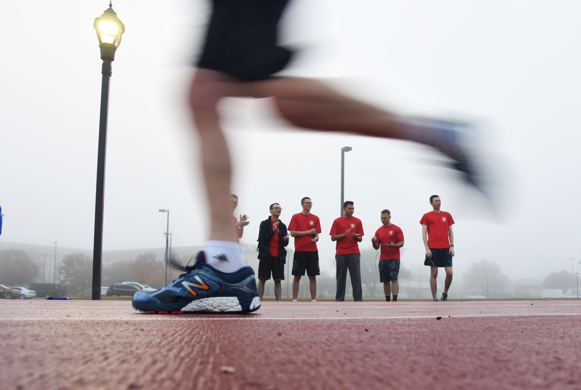 Members of the 336th Training Squadron cheer on Airmen during the 8th annual Dragon Challenge at the triangle track Dec. 1, 2017, on Keesler Air Force Base, Mississippi. The base-wide event was held to bring together Airmen to promote physical training throughout the holidays. (U.S. Air Force photo by Kemberly Groue)