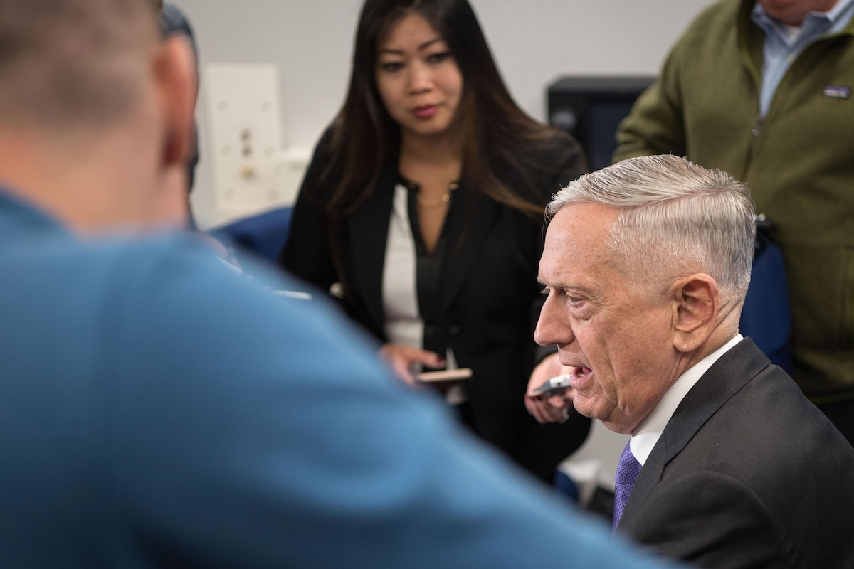 Defense Secretary James N. Mattis talks to reporters aboard an aircraft.