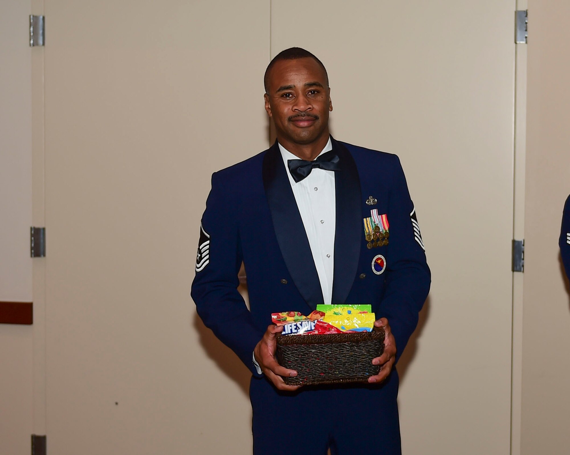 Master Sgt. Imari Motley, 460th Force Support Squadron Airman Leadership School commandant, receives a gift from ALS Class 18-A during their graduation Nov. 29, 2017, on Buckley Air Force Base, Colorado.