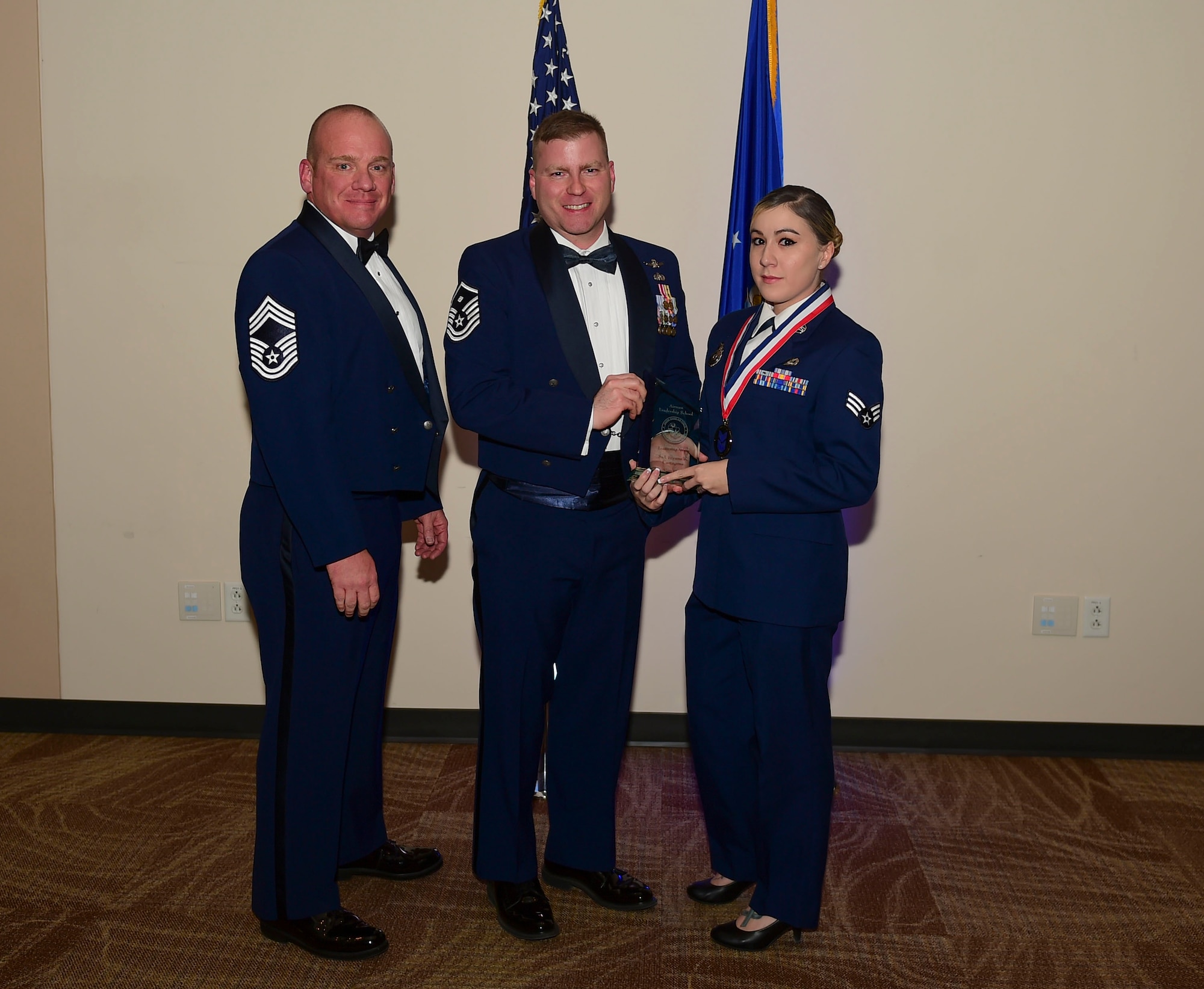 Senior Airman Illyana Cartagena, 460th Security Forces Squadron reports and analysis NCO in charge, receives the Leadership Award during the Airmen Leadership School Class 18-A graduation Nov. 29, 2017, on Buckley Air Force Base, Colorado.