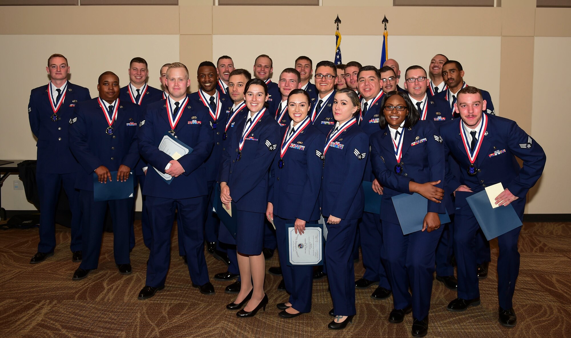 Airman Leadership School class 18-A pose together for the last time during their graduation ceremony Nov. 29, 2017, on Buckley Air Force Base, Colorado.