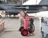 Image of Airman 1st Class Carol Russell, a 391st Aircraft Maintenance Unit F-15E avionics technician, inspects a 150 pound Halon Fire Bottle Nov. 29, 2017, at Mountain Home Air Force Base, Idaho. While the jet prepares to take off, Russell's job is to stand next to the fire bottle ready to extinguish any fires that may occur. (U.S. Air Force photo by Airman 1st Class Alaysia Berry)