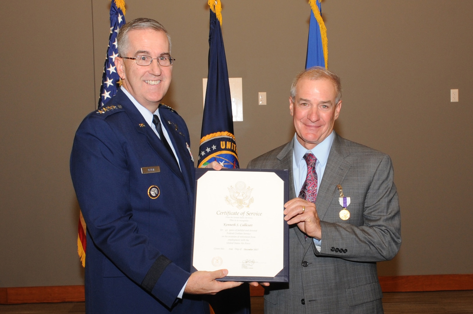 U.S. Air Force Gen. John Hyten, commander of U.S. Strategic Command (USSTRATCOM), presents a certificate of service to Kenneth Callicutt, USSTRATCOM director of capability and resource integration, during his retirement ceremony at Offutt Air Force Base, Neb., Dec. 1, 2017. Callicutt retired after more than 39 years of service as an Air Force officer and member of the Senior Executive Service. During his 12 years with USSTRATCOM, Callicutt led the team responsible for conducting force management and analysis to include integrating, and advocating future concepts, weapons system development, support for emerging technologies, and command and control architecture. One of nine Department of Defense unified combatant commands, USSTRATCOM has global responsibilities assigned through the Unified Command Plan that include strategic deterrence, nuclear operations, space operations, joint electromagnetic spectrum operations, global strike, missile defense, and analysis and targeting.