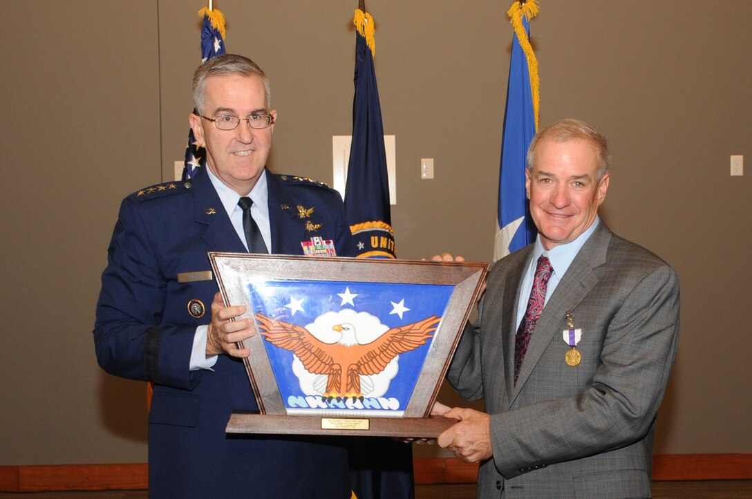 U.S. Air Force Gen. John Hyten, commander of U.S. Strategic Command (USSTRATCOM) presents a shadow box to Kenneth Callicutt, USSTRATCOM director of capability and resource integration, during his retirement ceremony at Offutt Air Force Base, Neb., Dec. 1, 2017. Callicutt retired after more than 39 years of service as an Air Force officer and member or the Senior Executive Service. During his 12 years with USSTRATCOM, Callicutt led the team responsible for conducting force management and analysis to include integrating, and advocating future concepts, weapons system development, support for emerging technologies, and command and control architecture. One of nine Department of Defense unified combatant commands, USSTRATCOM has global responsibilities assigned through the Unified Command Plan that include strategic deterrence, nuclear operations, space operations, joint electromagnetic spectrum operations, global strike, missile defense, and analysis and targeting.
