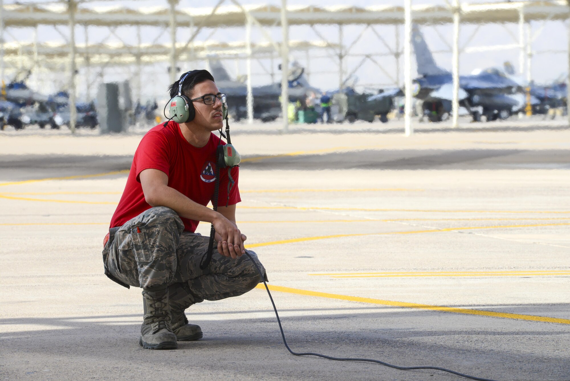 Airman 1st Class Austin Tow, 63rd Aircraft Maintenance Unit crew chief, prepares to marshal an F-35A Lightning II at Luke Air Force Base, Ariz., Dec. 1, 2017. Seven aircraft are currently assigned to the 63rd Fighter Squadron with the number expected to reach 22 in the near future. (U.S. Air Force photo/Airman 1st Class Caleb Worpel)