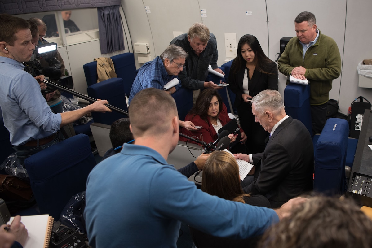 Defense Secretary James N. Mattis talks to reporters aboard an aircraft.