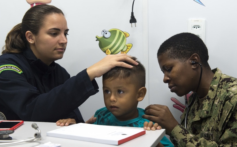 Doctors treat a child patient in Brazil.