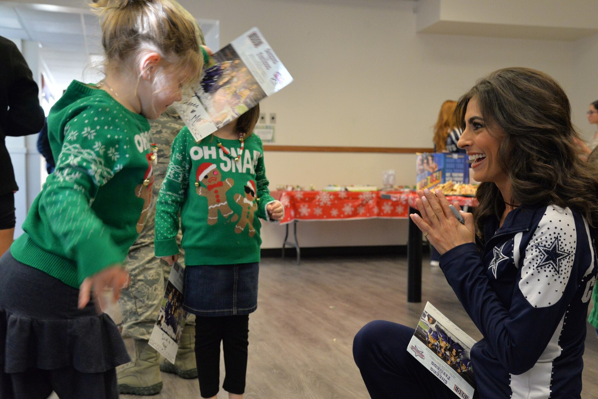 Dallas Cowboys Cheerleader Jinelle Esther, spends time with deployed affected families during a luncheon at the base chapel Dec. 2, 2017, at Malmstrom Air Force Base, Mont.
