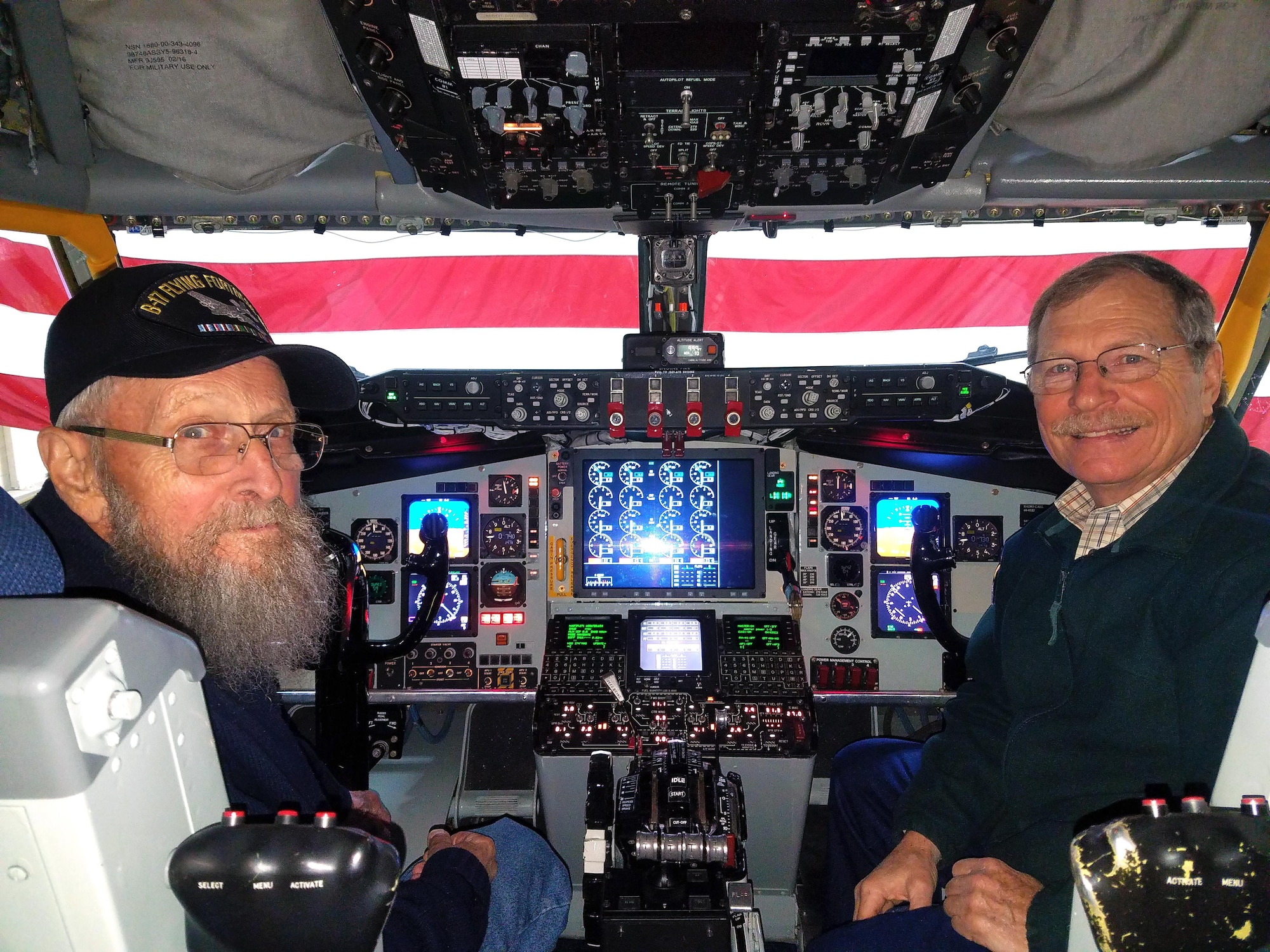 Robert Tobey and Dave Hankins pose for a photo inside of the cockpit of a KC-135R Stratotanker at Grissom Air Reserve Base, Ind., Oct. 27, 2017. Tobey, who piloted a B-17 Flying Fortress during World War II, was invited to tour Grissom and performed a simulated Stratotanker flight. (U.S. Air Force photo / Senior Airman Harrison Withrow)