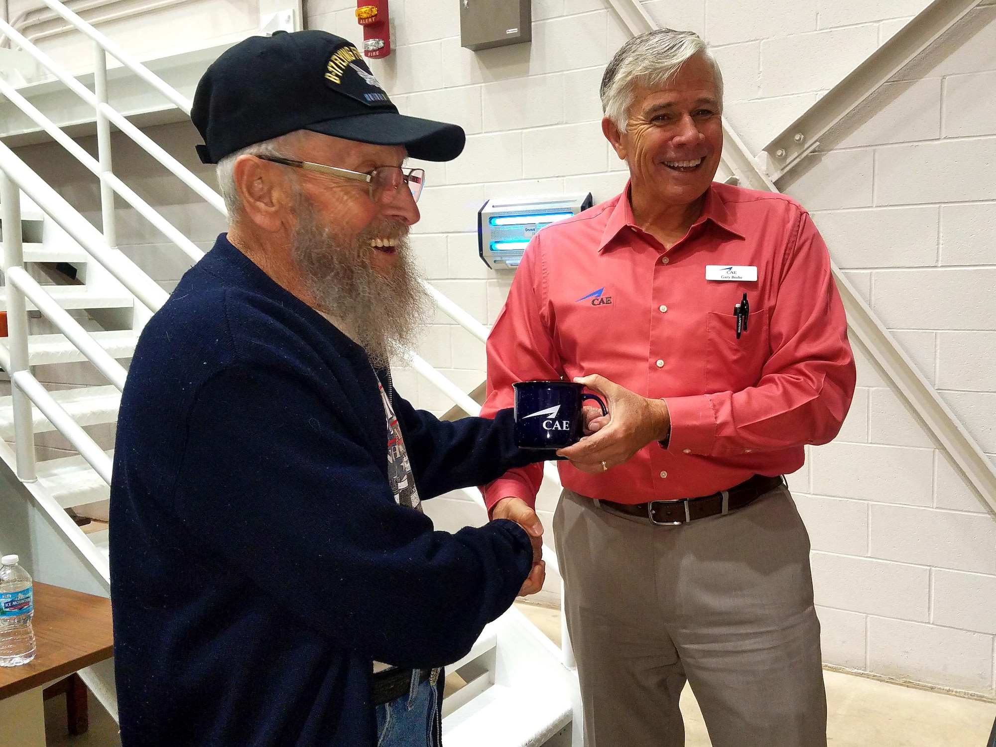 Gary Beebe, Grissom’s site focal pilot, presents Robert Tobey with a commemorative mug at Grissom Air Reserve Base, Ind., Oct. 27, 2017. 94-year-old Tobey piloted a B-17 Flying Fortress over Europe during World War II with the United States Army Air Corps. (U.S. Air Force photo / Senior Airman Harrison Withrow)