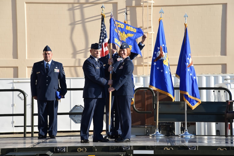 Col. Kurt A. Mathews, 920th Rescue Wing commander, presents the newly established 920th Logistics Readiness Squadron guidon to Col. Jeanne E. Bisesi, 920th Mission Support Group commander, Dec. 2 at Patrick Air Force Base Florida. The squadron falls under the 920th MSG, which is tasked with managing logistics, facilities, force protection, personnel, services and communications. (U.S. Air Force photo by Senior Airman Brandon Kalloo Sanes)