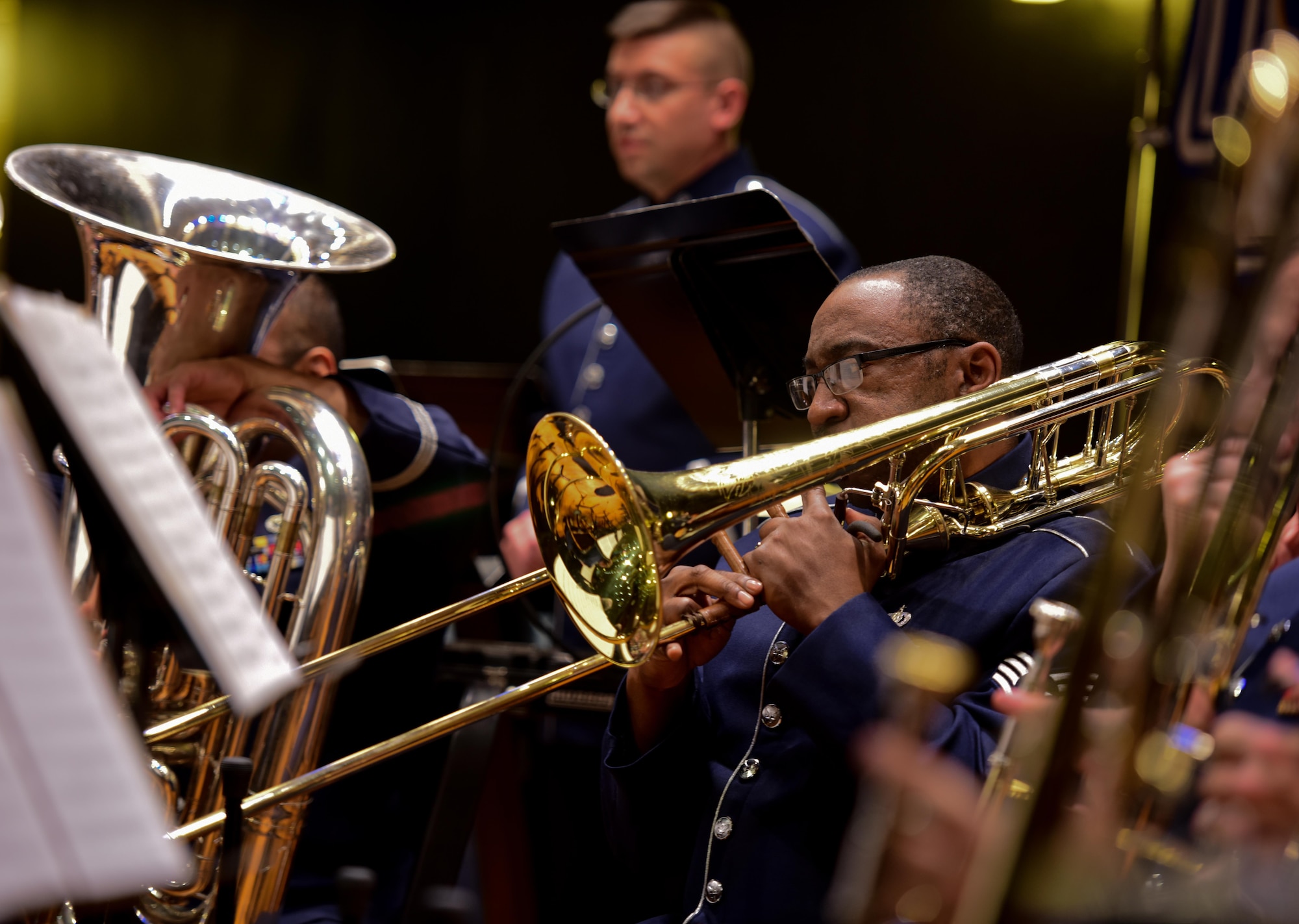 U.S. Air Force Staff Sgt. Dandrick Glenn, Pennsylvania Air National Guard Band of the Northeast trombone player, performs during a Christmas Festival concert held at Upper Dauphin Middle School in Lykens, Pennsylvania, Dec. 2, 2017. The band played an hour and a half-long show and invited the middle school students to play with them. (U.S. Air National Guard photo by Senior Airman Rachel Loftis/Released)