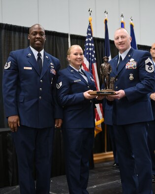 Chief Master Sgt. John Smith poses with Staff Sgt. Jaime Young and Tech. Sgt. Marcus Goins, who accepted the Chief's Award on behalf of the Enlisted Advisory Council (EAC) at the Annual Awards Ceremony at Hy-Vee Hall, Des Moines, Iowa on November 4, 2017. The EAC earned this award due to their continued work and dedication in raising the 132d Wing's Airmen and their families morale. (U.S. Air National Guard photo by Airman 1st Class Katelyn Sprott)