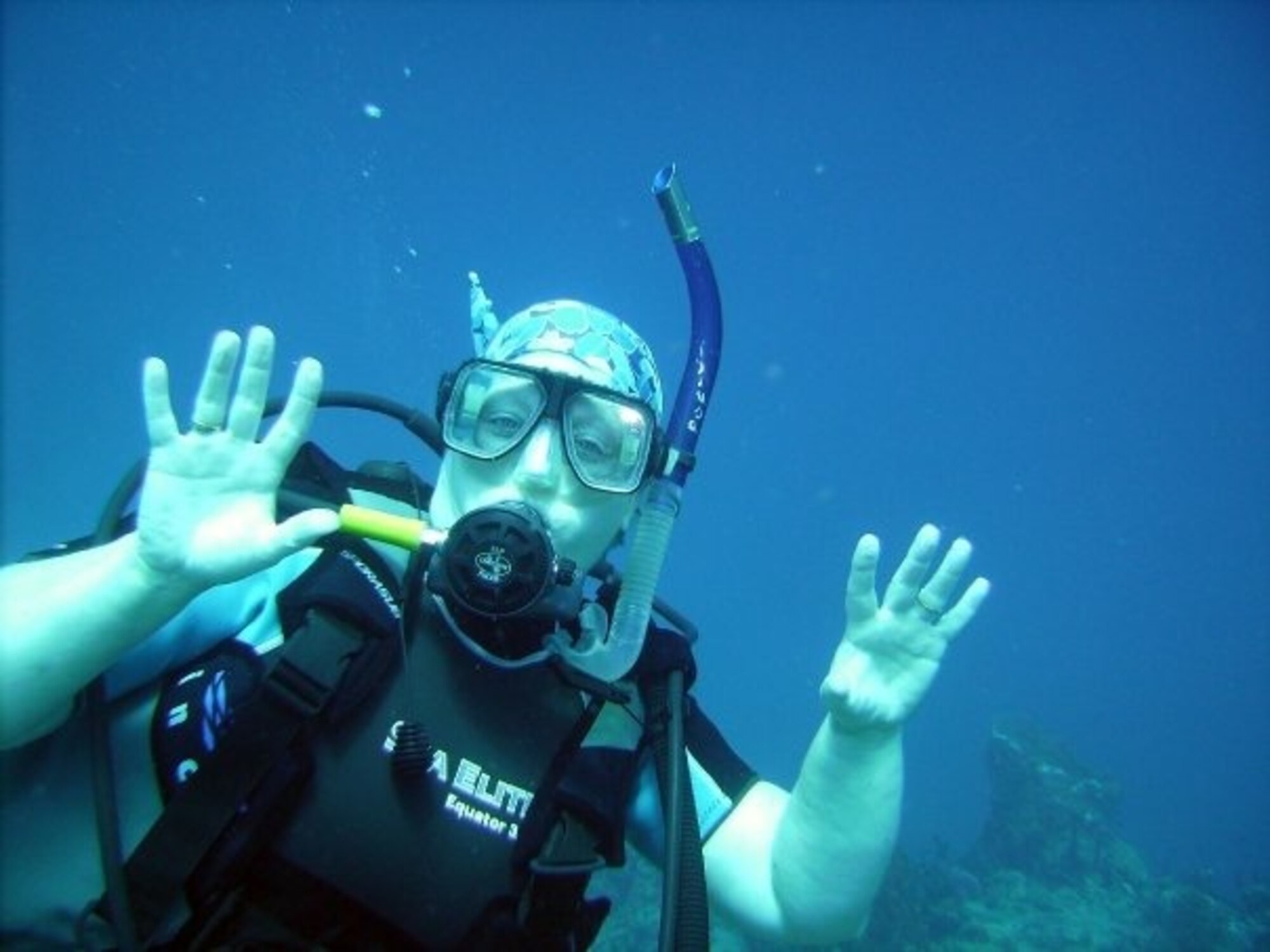 Tina Poe, 940th Air Refueling Wing Commander’s Secretary, poses underwater for the camera April 2012, in Roatan near Honduras.