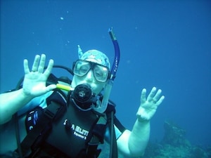 Tina Poe, 940th Air Refueling Wing Commander’s Secretary, poses underwater for the camera April 2012, in Roatan near Honduras.