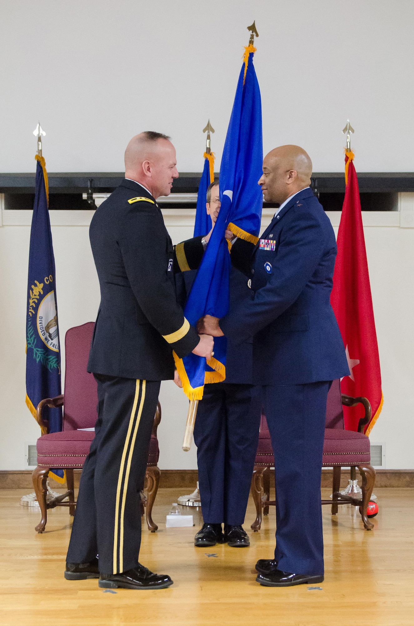 Army Maj. Gen. Steven R. Hogan (left), adjutant general of the Kentucky National Guard, presents the brigadier general flag to Charles M. Walker, chief of staff for Headquarters, Kentucky Air National Guard, during Walker’s promotion ceremony at the Kentucky Air National Guard base in Louisville, Ky., Nov. 4, 2017. (U.S. Air National Guard photo by Tech. Sgt. Vicky Spesard)