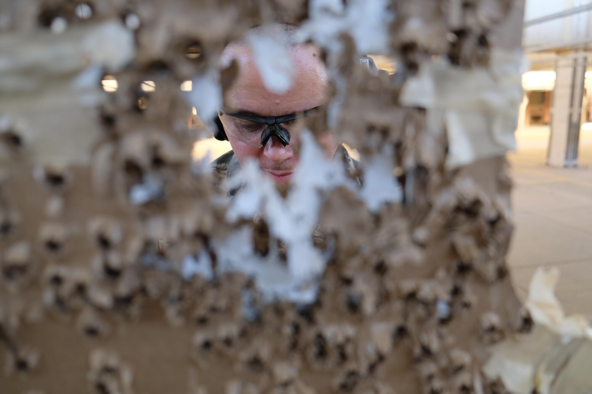 Staff Sgt. Leon Hardy, 931st Security Force Squadron combat arms training and maintenance instructor, evaluates a student’s target during a CATM course Dec. 2, 2017, at McConnell Air Force Base, Kan.