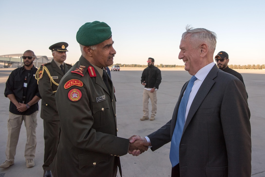 Defense Secretary James N. Mattis shakes hands with a Kuwaiti military officer.