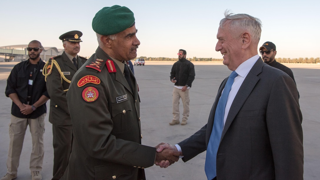 Defense Secretary James N. Mattis shakes hands with a Kuwaiti military officer.