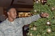 Tech. Sgt. Brandon Godfrey, Command Support Staff, 161st Air Refueling Wing, places an ornament on a Christmas tree in the wing's Dining Facility during the Unit Training Assembly here Dec. 3, 2017. Godfrey grew up playing basketball and seeks to use it as an instrument to teach children the value of integrity, hard work and dedication. (U.S. Air National Guard photo by 2nd Lt. Tinashe Machona)