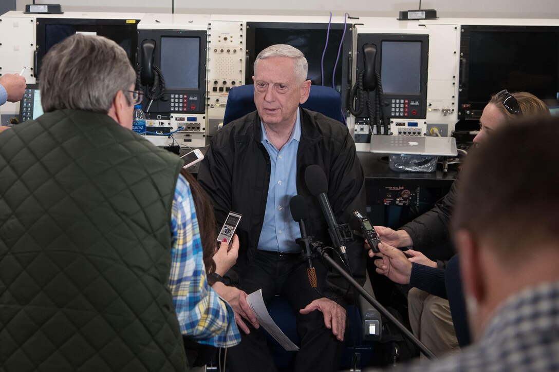 Defense Secretary James N. Mattis speaks with reporters aboard a plane.