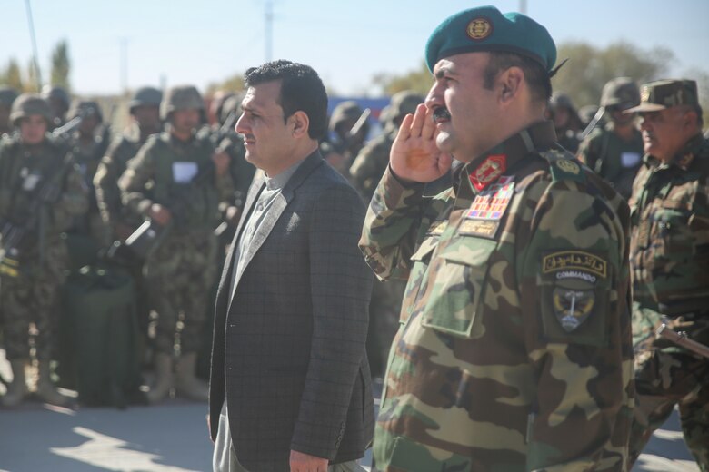 Sardar Mohammed Hamdard, left, the first deputy governor of Helmand province, and Afghan National Army Maj. Gen. Wali Mohammed Ahmadzai, center-right, the commanding general of 215th Corps, pass and review ANA soldiers with 6th Kandak, 1st Brigade, 215th Corps during a graduation ceremony at Camp Shorabak, Afghanistan, Dec. 3, 2017. The event concluded an eight-week operational readiness cycle, which was led by Afghan instructors at the Helmand Regional Military Training Center. Hundreds of soldiers with 6th Kandak, 1st Brigade developed their individual and collective infantry skills throughout the course to more effectively combat the Taliban in the province. (U.S. Marine Corps photo by Sgt. Lucas Hopkins)