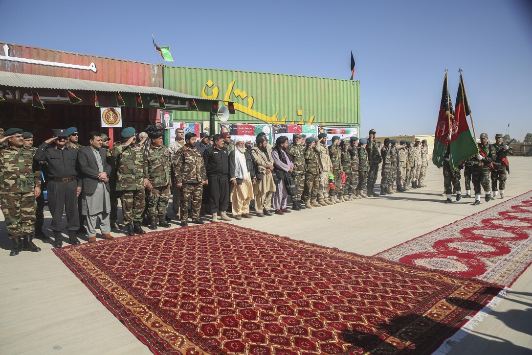 The Afghan National Army 215th Corps color guard marches the Afghan national colors past Helmand province and Afghan National Defense and Security Force key leaders during a graduation ceremony at Camp Shorabak, Afghanistan, Dec. 3, 2017. The ceremony marked the end of the 6th Kandak, 1st Brigade 215th Corps’ operational readiness cycle, an eight-week course led by Afghan instructors at the Helmand Regional Military Training Center. Approximately 350 soldiers with the unit trained to enhance their infantry capabilities and will support Afghan National Defense and Security Force combat operations throughout the province. (U.S. Marine Corps photo by Lucas Hopkins)