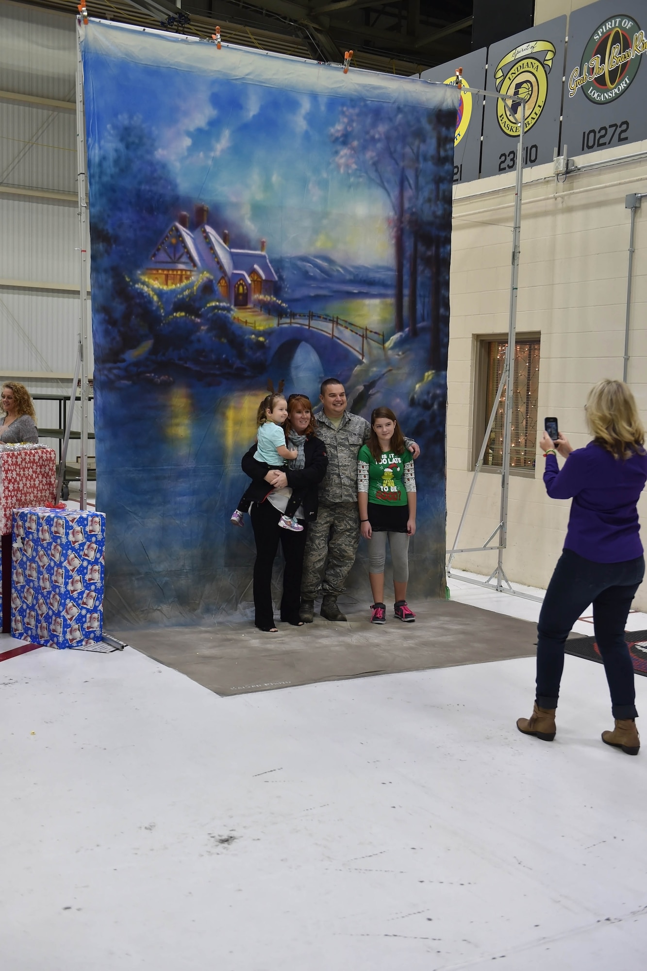 Samantha Hagen, Serenity Hagen, Trinity Hagen and Tech Sgt. Keith Hagen, 434th Maintenance Squadron munitions stockpile management, pose for a pamily photo during a Christmas celebration. The celebration took place during Grissom’s Christmas childrens party here Dec. 2. (U.S. Air Force photo/Staff Sgt. Jami K. Lancette)