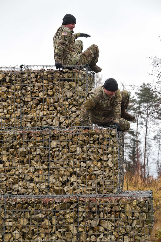 Soldiers climb down an obstacle during the brigade’s first senior leader physical challenge.