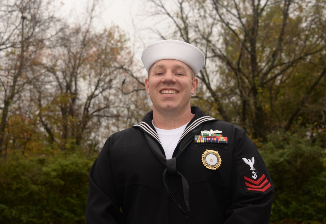 A sailor poses for a photo